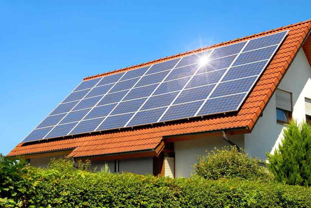 Solar Panels On Red Roof Reflecting The Sun